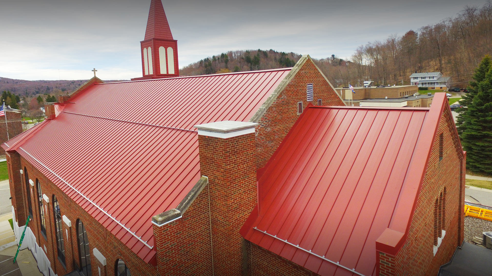 Red metal roof on a Catholic Church.